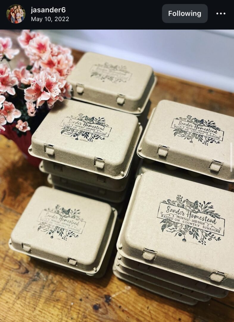 Stacked cardboard boxes with floral design labels.