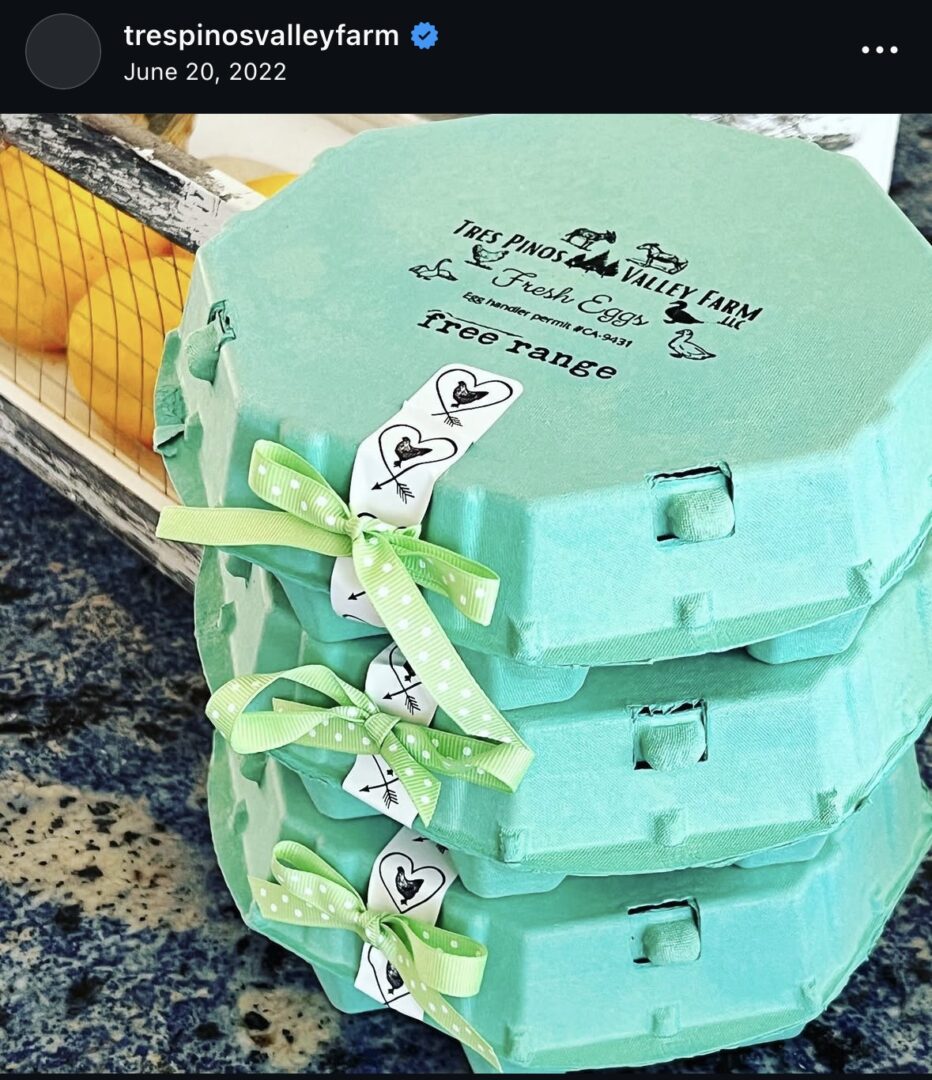 Stacked green egg cartons with decorative ribbons.
